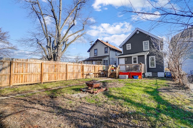 back of house featuring a yard and a deck