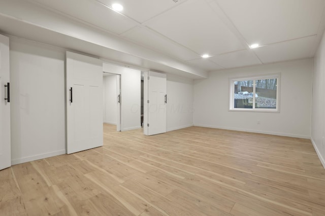 basement with light hardwood / wood-style floors