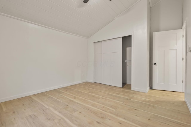 unfurnished bedroom with light wood-type flooring and lofted ceiling