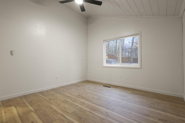 empty room with ceiling fan, wooden ceiling, vaulted ceiling, and light wood-type flooring