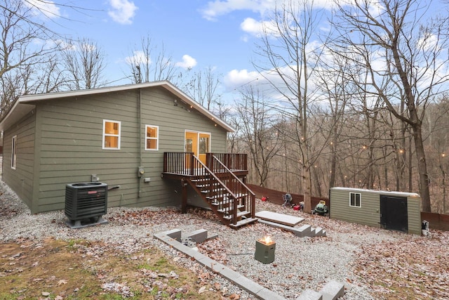 rear view of house with central air condition unit and a deck