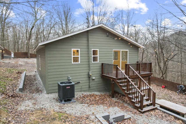 rear view of property with central AC and a deck