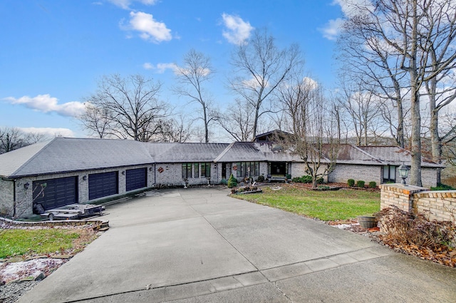 ranch-style house with a garage and a front lawn