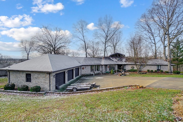 ranch-style house with a front yard and a garage