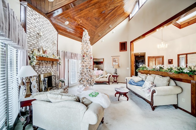 living room featuring carpet floors, a fireplace, high vaulted ceiling, and an inviting chandelier