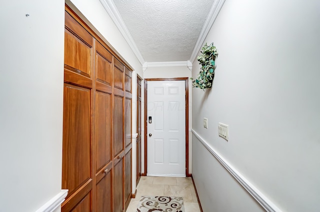 doorway to outside featuring a textured ceiling, crown molding, and light tile patterned flooring