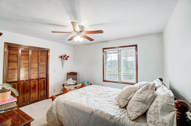 carpeted bedroom featuring a closet and ceiling fan