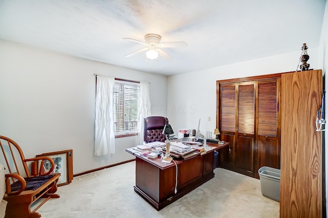 carpeted home office with ceiling fan