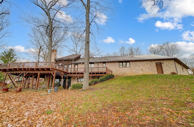 rear view of house with a yard and a deck