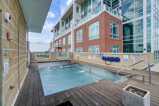 view of swimming pool with pool water feature