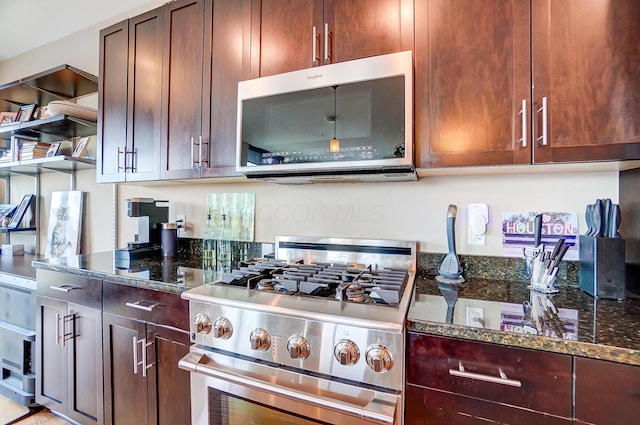 kitchen featuring appliances with stainless steel finishes and dark stone countertops