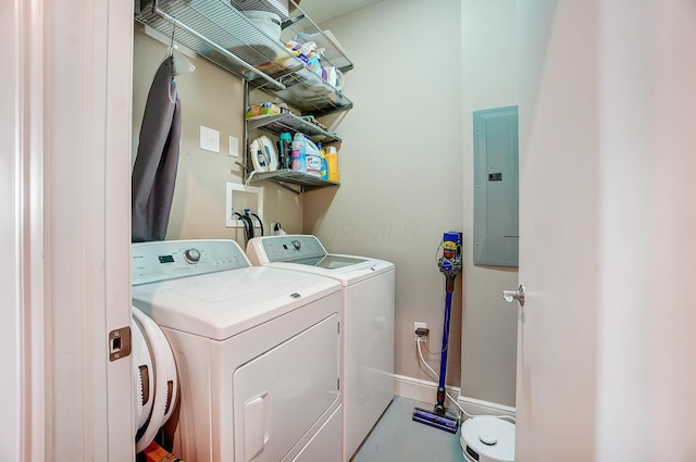 clothes washing area with electric panel and washer and dryer