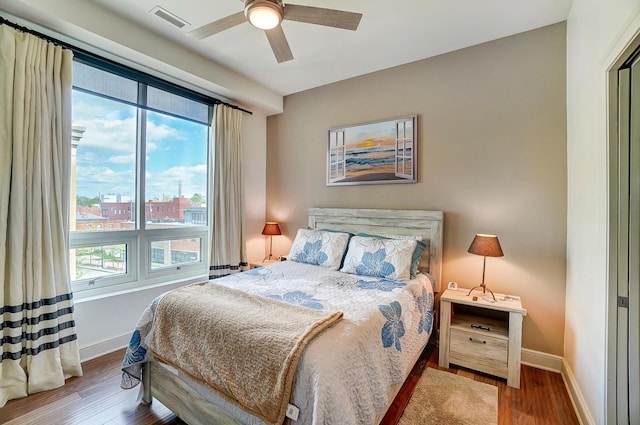 bedroom with ceiling fan and hardwood / wood-style floors