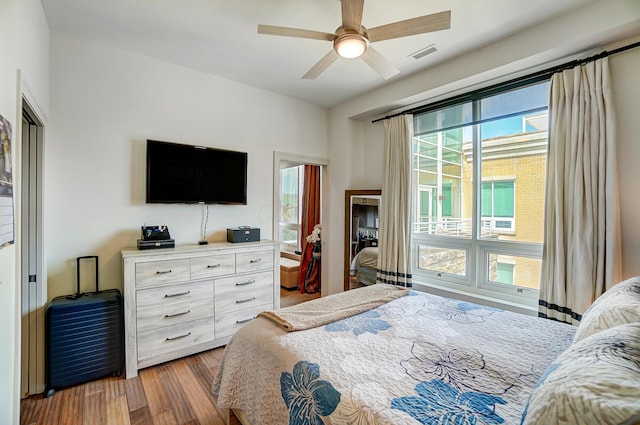 bedroom with ceiling fan and light wood-type flooring