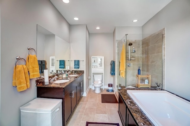 full bathroom with tile patterned flooring, shower with separate bathtub, vanity, and toilet