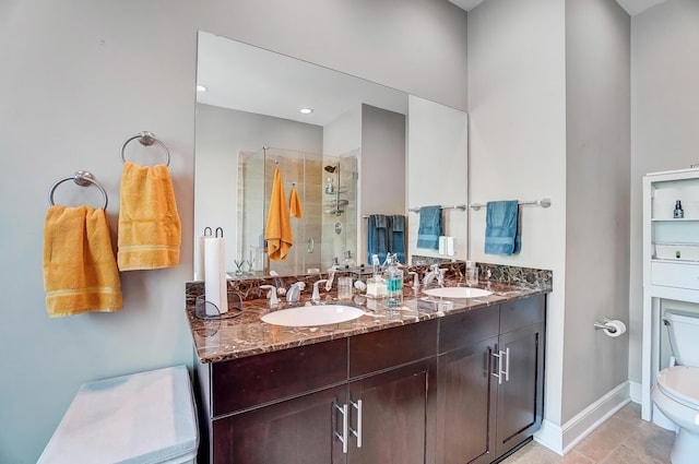 bathroom with tile patterned floors, vanity, toilet, and an enclosed shower