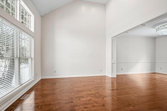 empty room with lofted ceiling and hardwood / wood-style floors