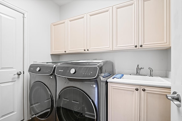 clothes washing area with cabinets, sink, and independent washer and dryer