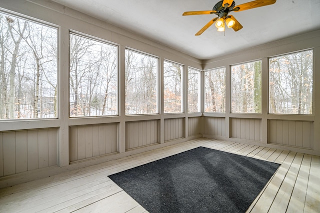 unfurnished sunroom with ceiling fan and a healthy amount of sunlight