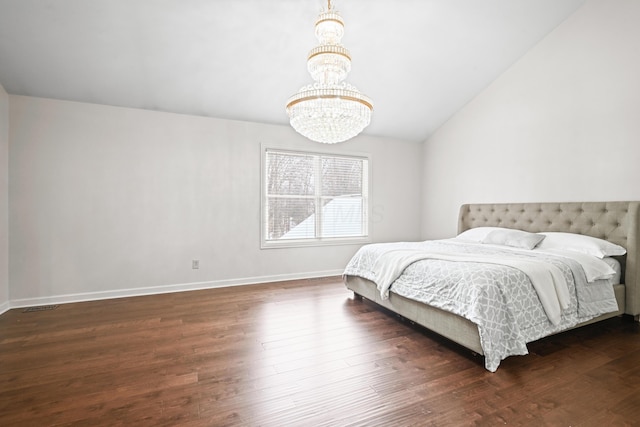 bedroom with lofted ceiling, dark hardwood / wood-style floors, and a chandelier