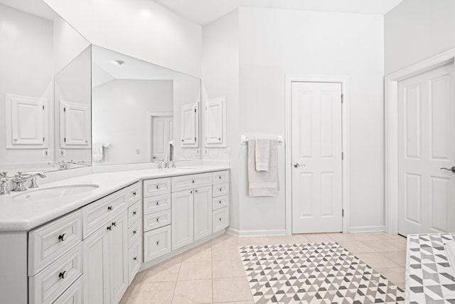 bathroom featuring tile patterned flooring, vanity, and lofted ceiling