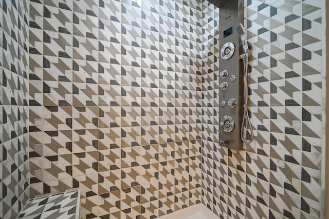 interior details featuring a tile shower