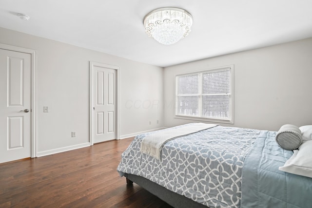 bedroom with dark hardwood / wood-style floors