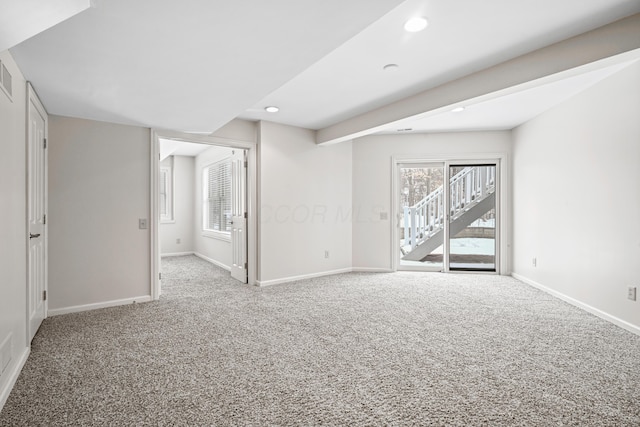 spare room featuring light colored carpet