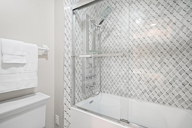 bathroom featuring combined bath / shower with glass door