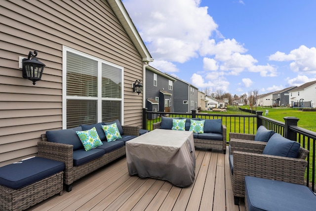 deck with outdoor lounge area and a yard