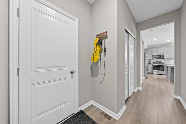 hallway with light hardwood / wood-style flooring