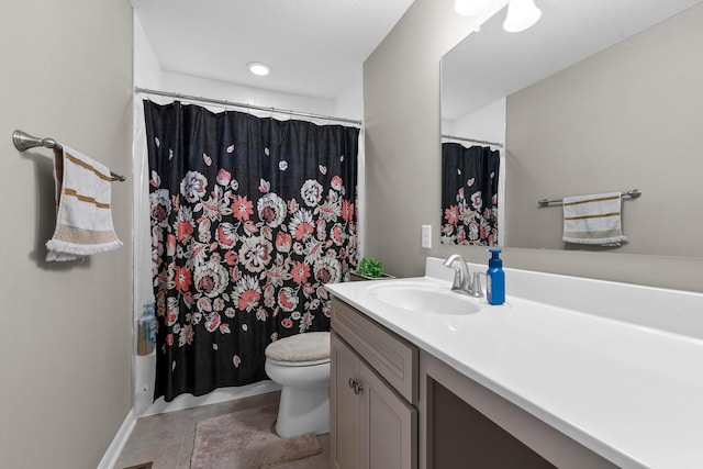 bathroom featuring tile patterned floors, vanity, and toilet