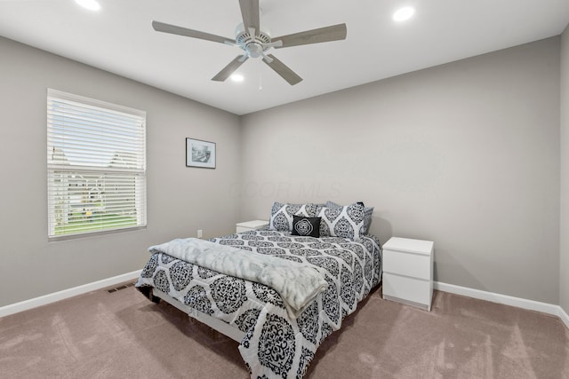 bedroom featuring ceiling fan and light carpet