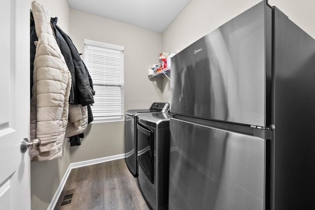 laundry area featuring wood-type flooring and separate washer and dryer