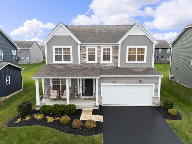 view of front of property featuring covered porch and a garage