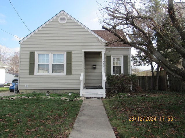 bungalow-style house featuring a front yard