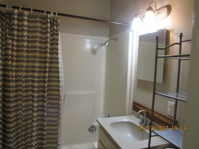 bathroom featuring vanity and curtained shower