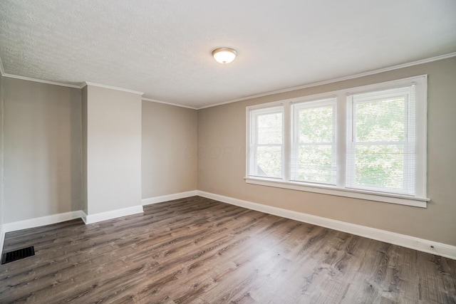 empty room featuring crown molding and dark hardwood / wood-style flooring