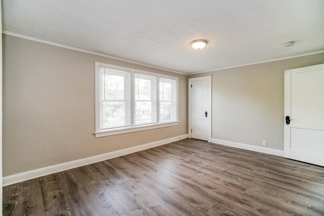 unfurnished room featuring hardwood / wood-style floors, ornamental molding, and a textured ceiling