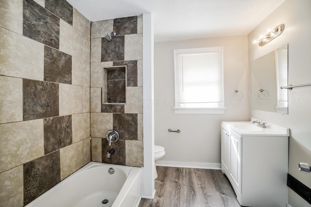 full bathroom with wood-type flooring, vanity, toilet, and tiled shower / bath combo