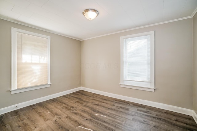 unfurnished room with dark hardwood / wood-style floors and crown molding