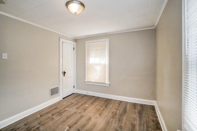 spare room with crown molding and light hardwood / wood-style floors