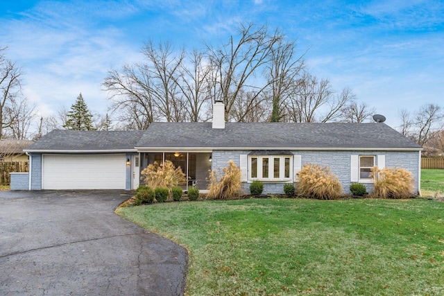 ranch-style home with a garage and a front lawn