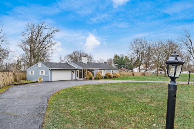 view of front of property with a front yard and a garage