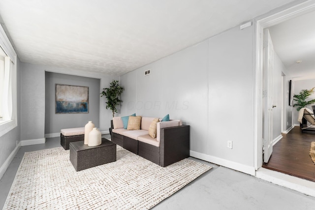 living room with concrete flooring