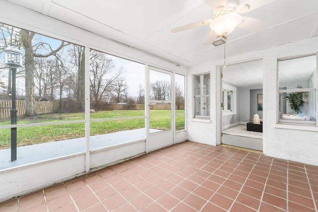 unfurnished sunroom featuring ceiling fan