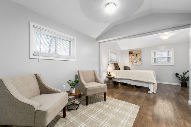 bedroom with hardwood / wood-style flooring, vaulted ceiling, and multiple windows