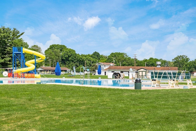 view of pool featuring a yard