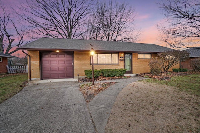 ranch-style home featuring a garage