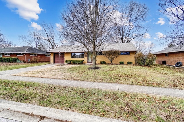 view of front of home with a front yard and a garage